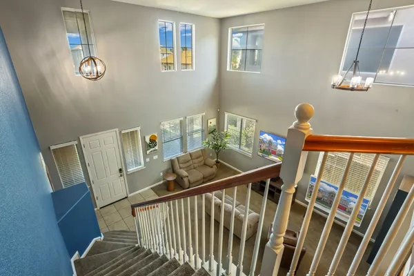 a view of a hallway with furniture and wooden floor