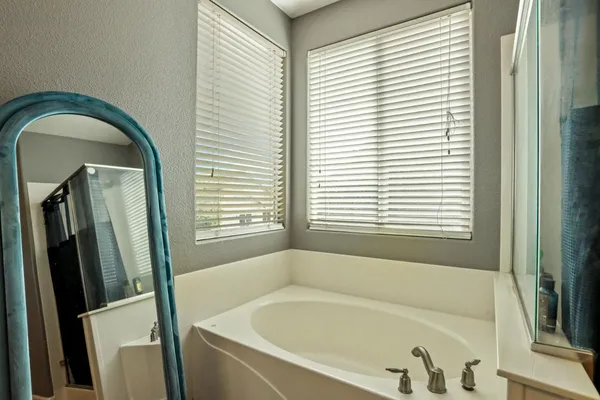 a white bath tub sitting next to a window