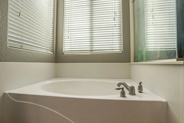 a bedroom with bed and a window