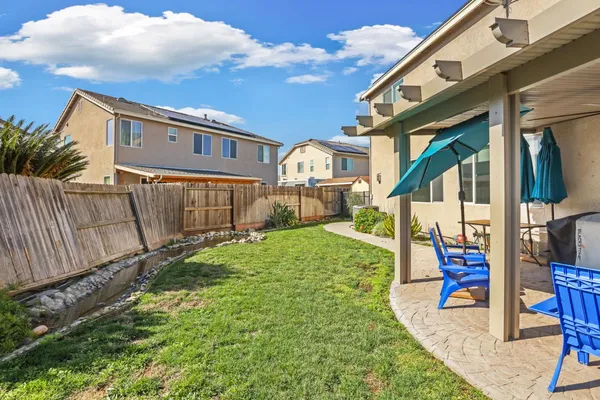 a swimming pool with outdoor seating and yard