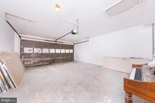 a view of a livingroom with wooden floor and a ceiling fan