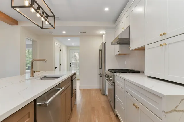 a kitchen with a sink appliances and cabinets