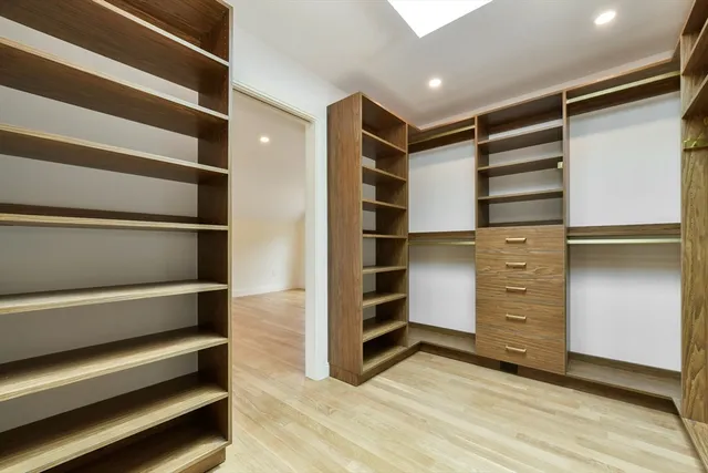 a view of walk in closet with empty racks
