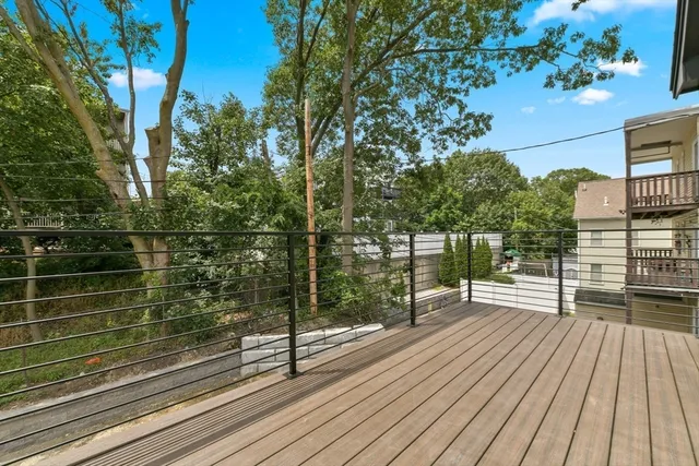 a view of a wooden deck with a yard