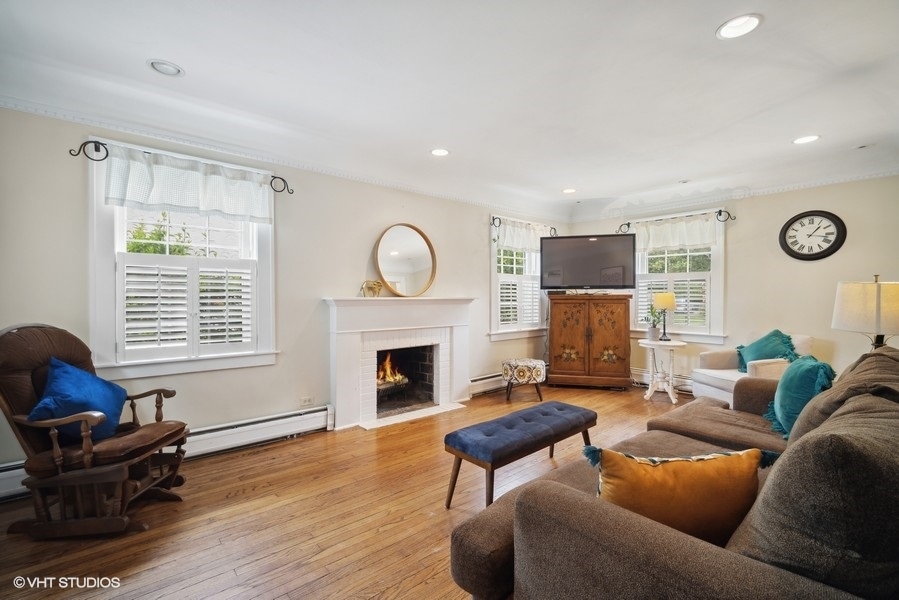 2129 Illinois Road Northbrook, IL 60062 - Photo 4 of 20 a living room with furniture flat screen tv and a fireplace