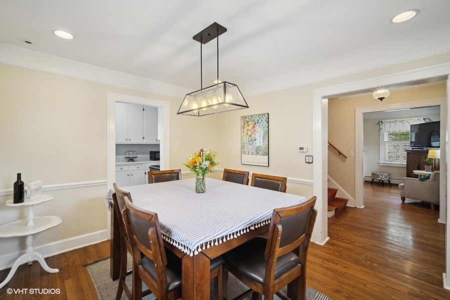 2129 Illinois Road Northbrook, IL 60062 - Photo 7 of 20 a view of a dining room and livingroom with furniture wooden floor a chandelier