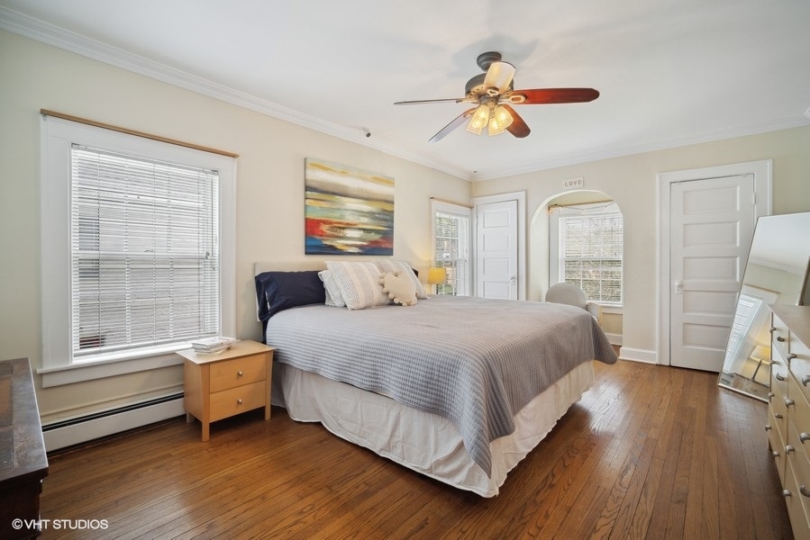 2129 Illinois Road Northbrook, IL 60062 - Photo 9 of 20 a spacious bedroom with a bed and wooden floor