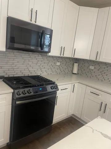 a kitchen with a stove and a microwave