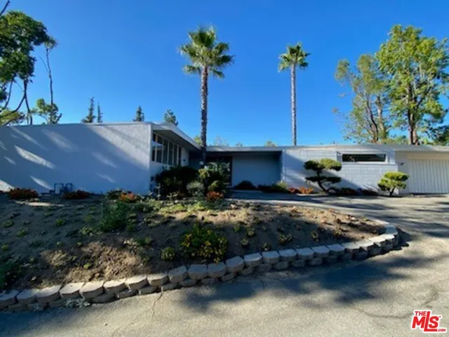 a view of a house with sitting area and a yard