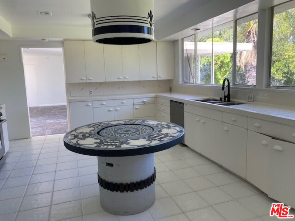 4014 Rogen Drive Encino, CA 91436 - Photo 15 of 22 a kitchen with a sink a window and cabinets