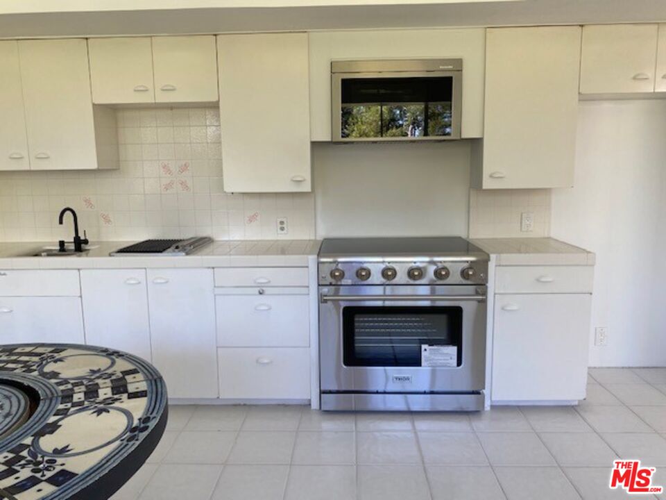 4014 Rogen Drive Encino, CA 91436 - Photo 16 of 22 a kitchen with granite countertop a stove and a sink