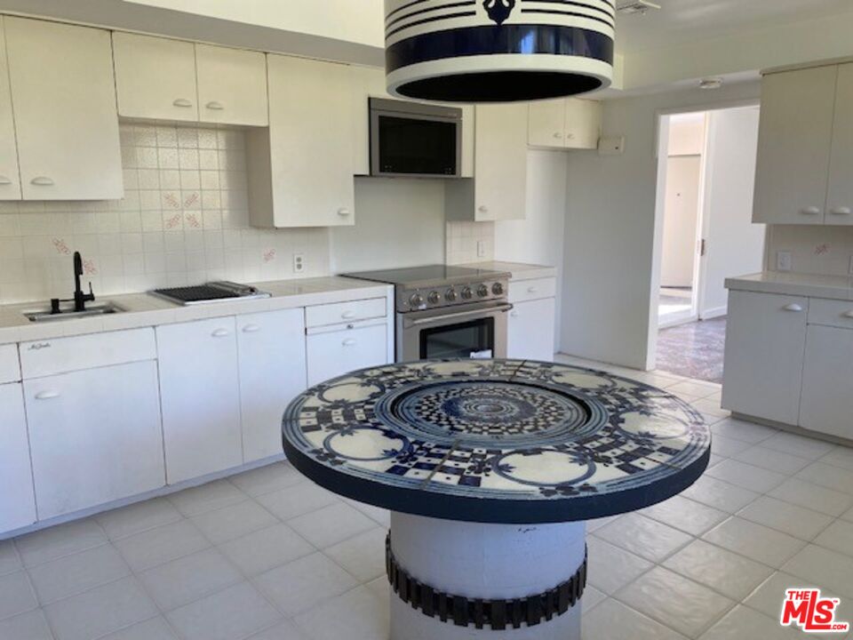 4014 Rogen Drive Encino, CA 91436 - Photo 17 of 22 a kitchen with a sink and cabinets