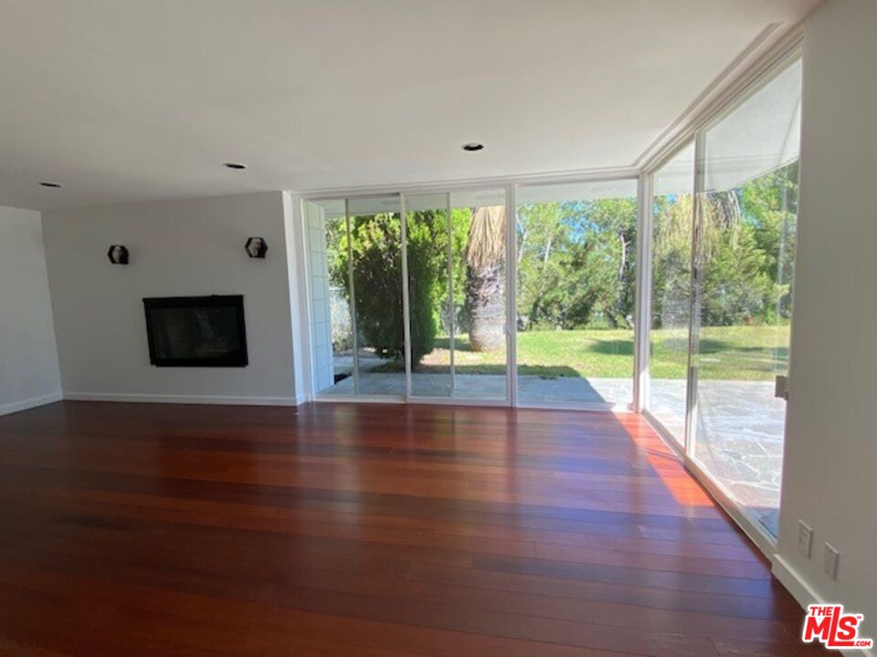4014 Rogen Drive Encino, CA 91436 - Photo 4 of 22 a view of empty room with wooden floor and fireplace
