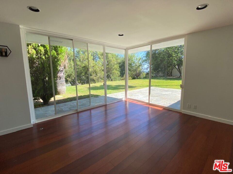 4014 Rogen Drive Encino, CA 91436 - Photo 5 of 22 a view of empty room with wooden floor and fan