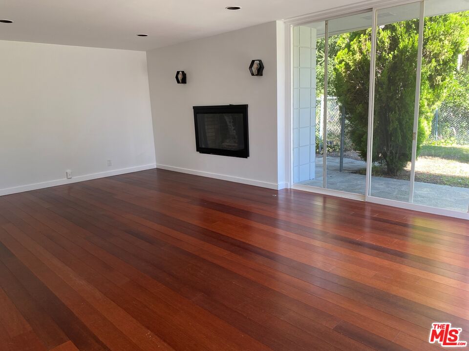 4014 Rogen Drive Encino, CA 91436 - Photo 6 of 22 a view of an empty room with wooden floor and a window