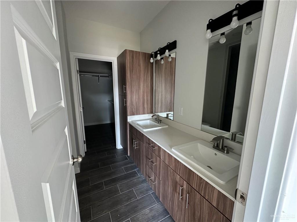 1703 Unity Drive Mercedes, TX 78570 - Photo 6 of 10 a bathroom with double vanity and mirrors