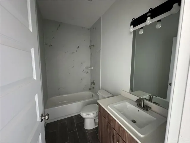 a view of an empty room and window and wooden floor