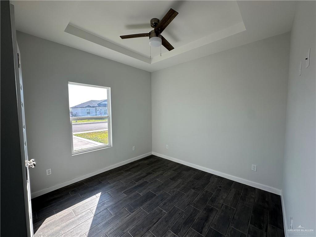 1703 Unity Drive Mercedes, TX 78570 - Photo 9 of 10 a view of an empty room and window and wooden floor