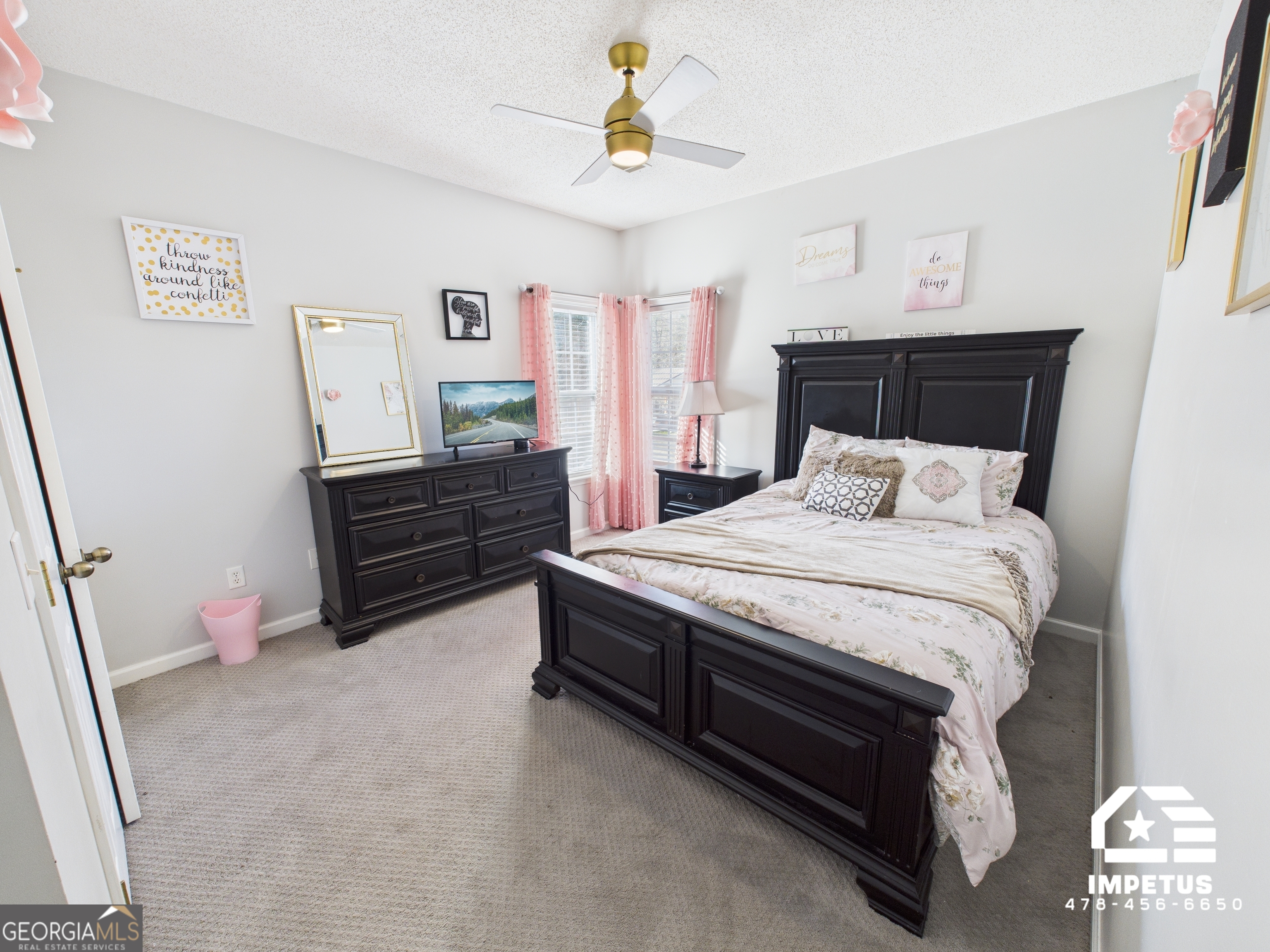 100 Crystal Ridge Road Northwest Milledgeville, GA 31061 - Photo 16 of 53 a bedroom with a bed and a chandelier