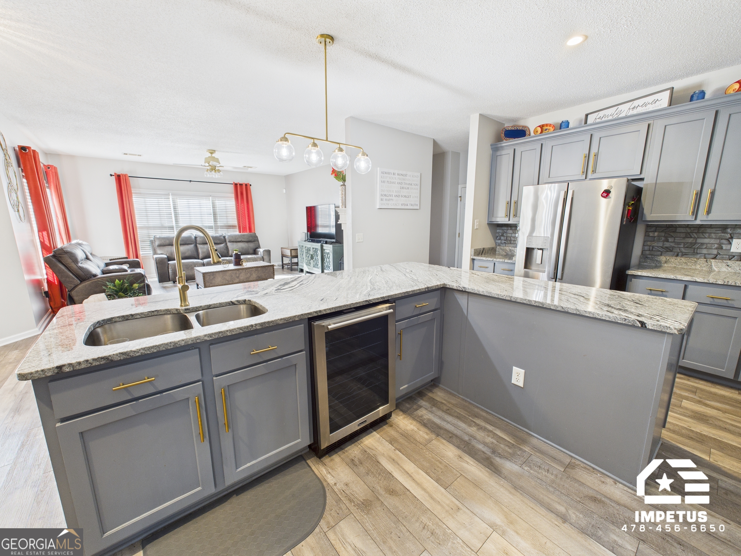 100 Crystal Ridge Road Northwest Milledgeville, GA 31061 - Photo 17 of 53 a kitchen with refrigerator cabinets and wooden floor
