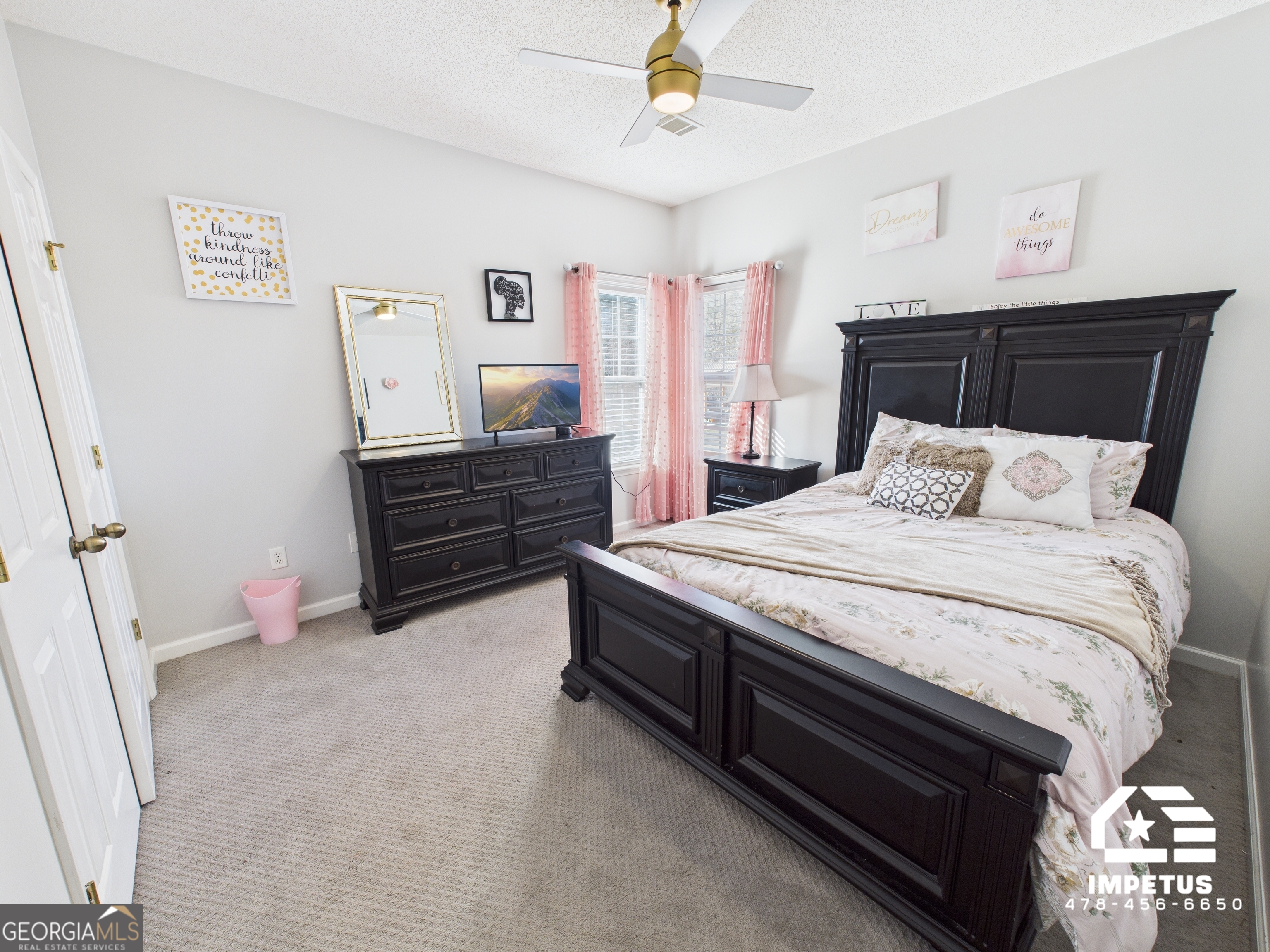 100 Crystal Ridge Road Northwest Milledgeville, GA 31061 - Photo 53 of 53 a bedroom with a bed and a chandelier