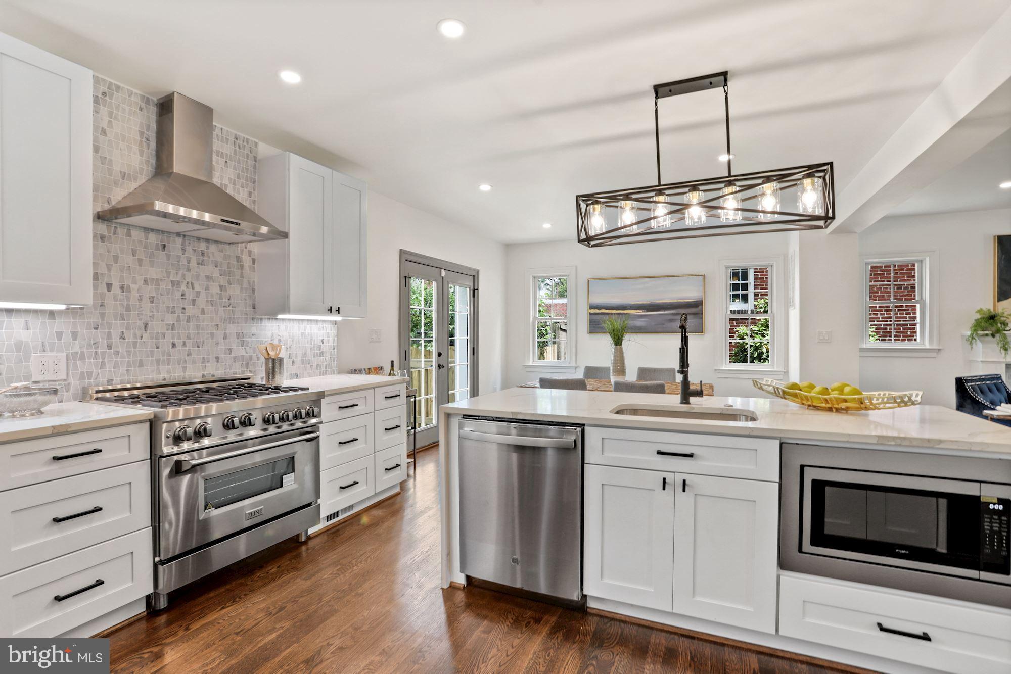 a kitchen with a stove and white cabinets