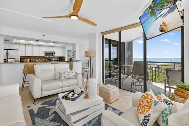 a living room with furniture and a view of kitchen