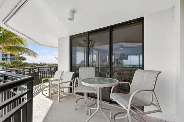 a dining room with furniture and a floor to ceiling window