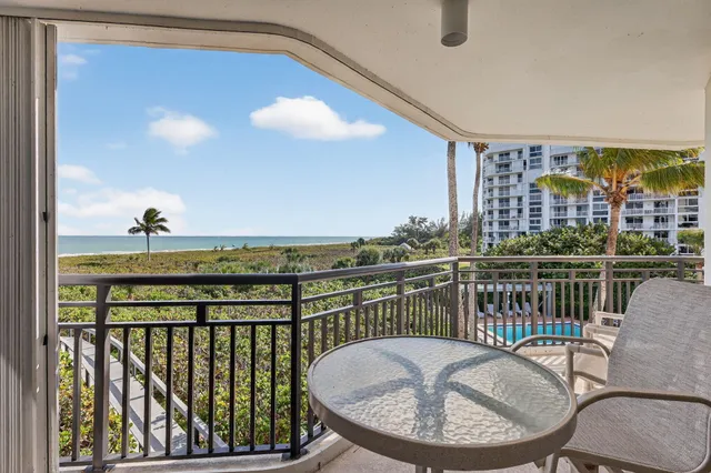 a bedroom with a balcony a bed and a flat screen tv