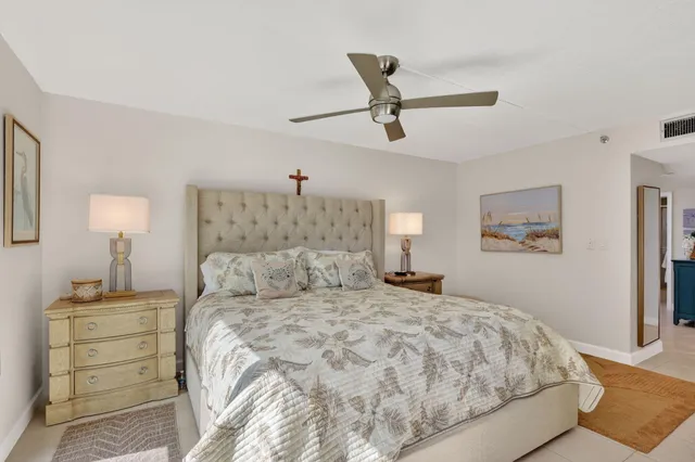 a bathroom with a granite countertop sink a mirror and shower