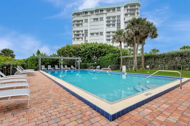 a picture of a building with a yard and plants
