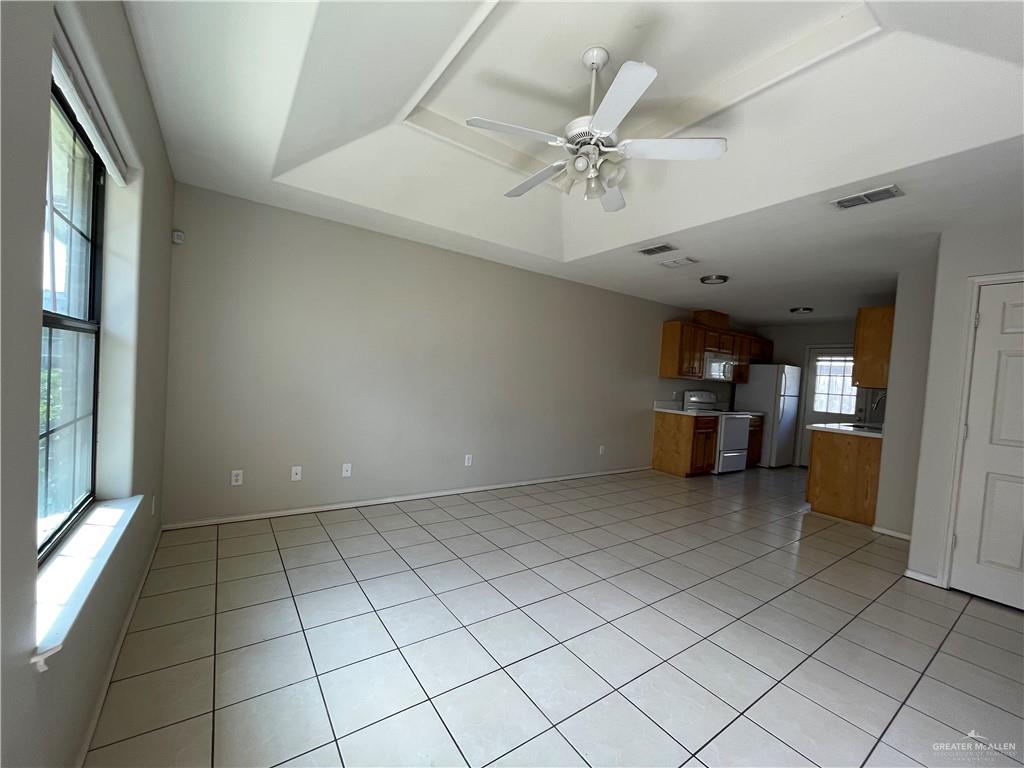 2311 Dora Jeanne, Unit A Mission, TX 78574 - Photo 3 of 9 en empty room with kitchen view and a window