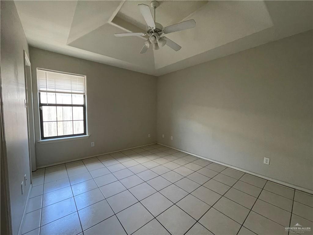 2311 Dora Jeanne, Unit A Mission, TX 78574 - Photo 6 of 9 an empty room with a ceiling fan and window