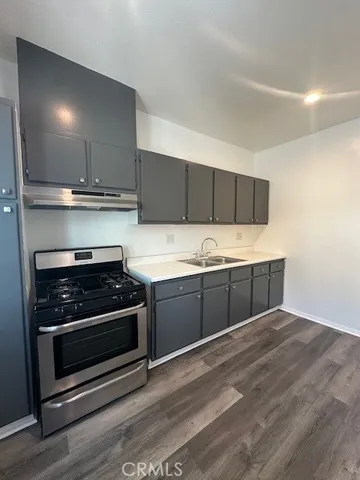 a kitchen with stainless steel appliances granite countertop a stove and a sink