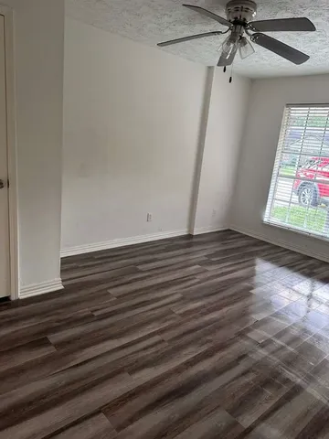 a view of room with window and hardwood floor