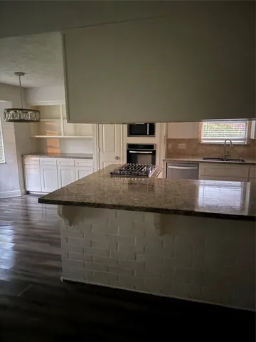 a kitchen with counter top space and appliances