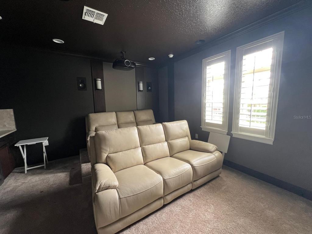 12927 Canopy Woods Way Winter Garden, FL 34787 - Photo 28 of 41 a living room with furniture and a window