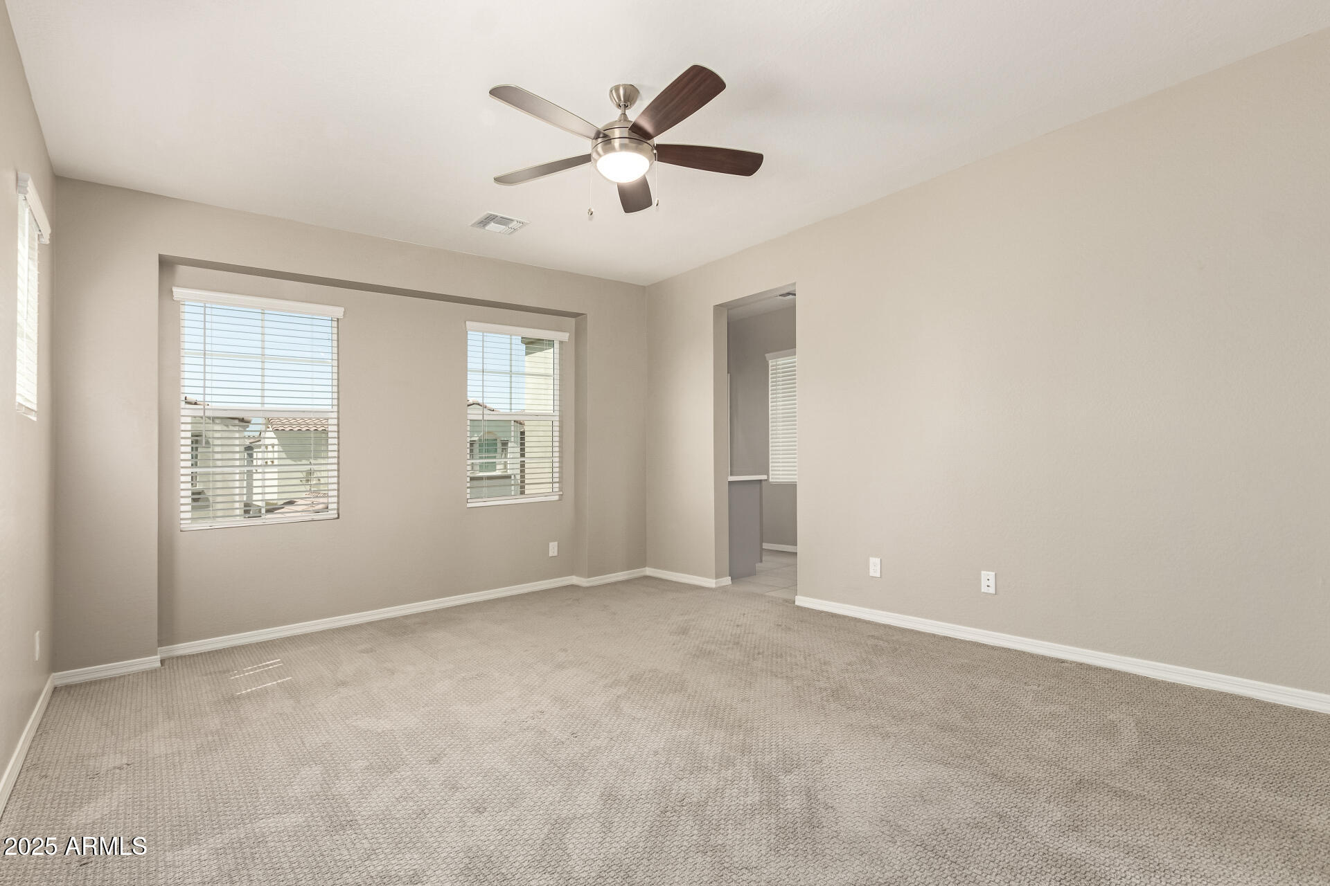 1535 East Dublin Street Gilbert, AZ 85295 - Photo 12 of 31 an empty room with windows and ceiling fan