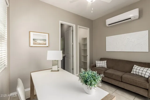 a living room with furniture and a potted plant