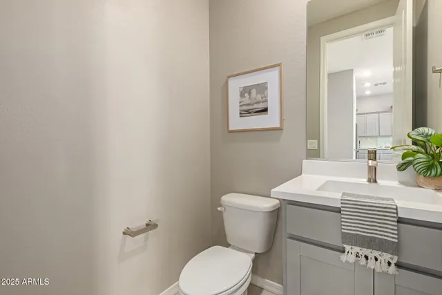 a white toilet sitting next to a white sink