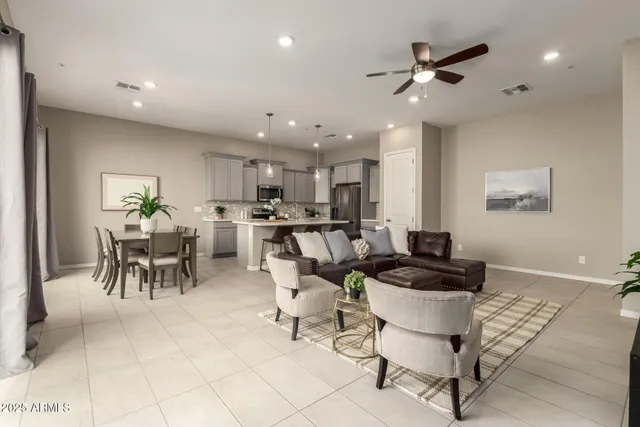 a living room with furniture and kitchen view