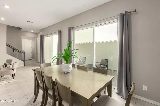 a dining room with furniture and window