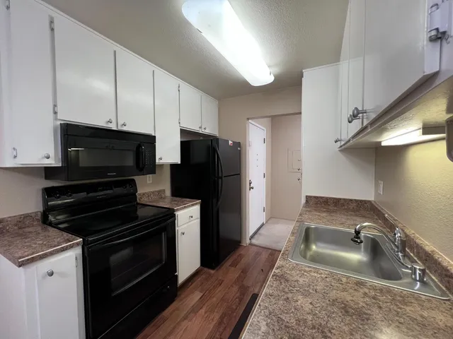 a kitchen with a sink stove and refrigerator