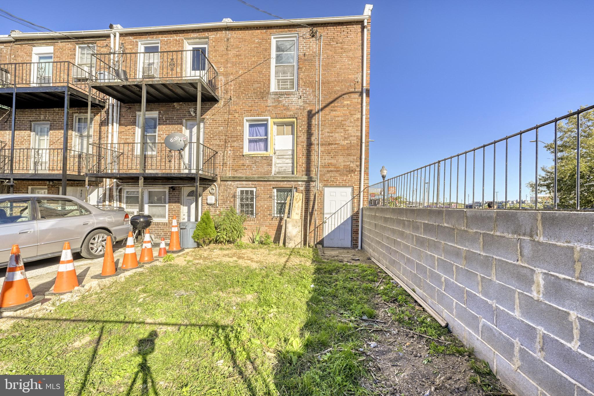 466 Hornel Street Baltimore, MD 21224 - Photo 15 of 19 a view of a house with a tub and wooden fence