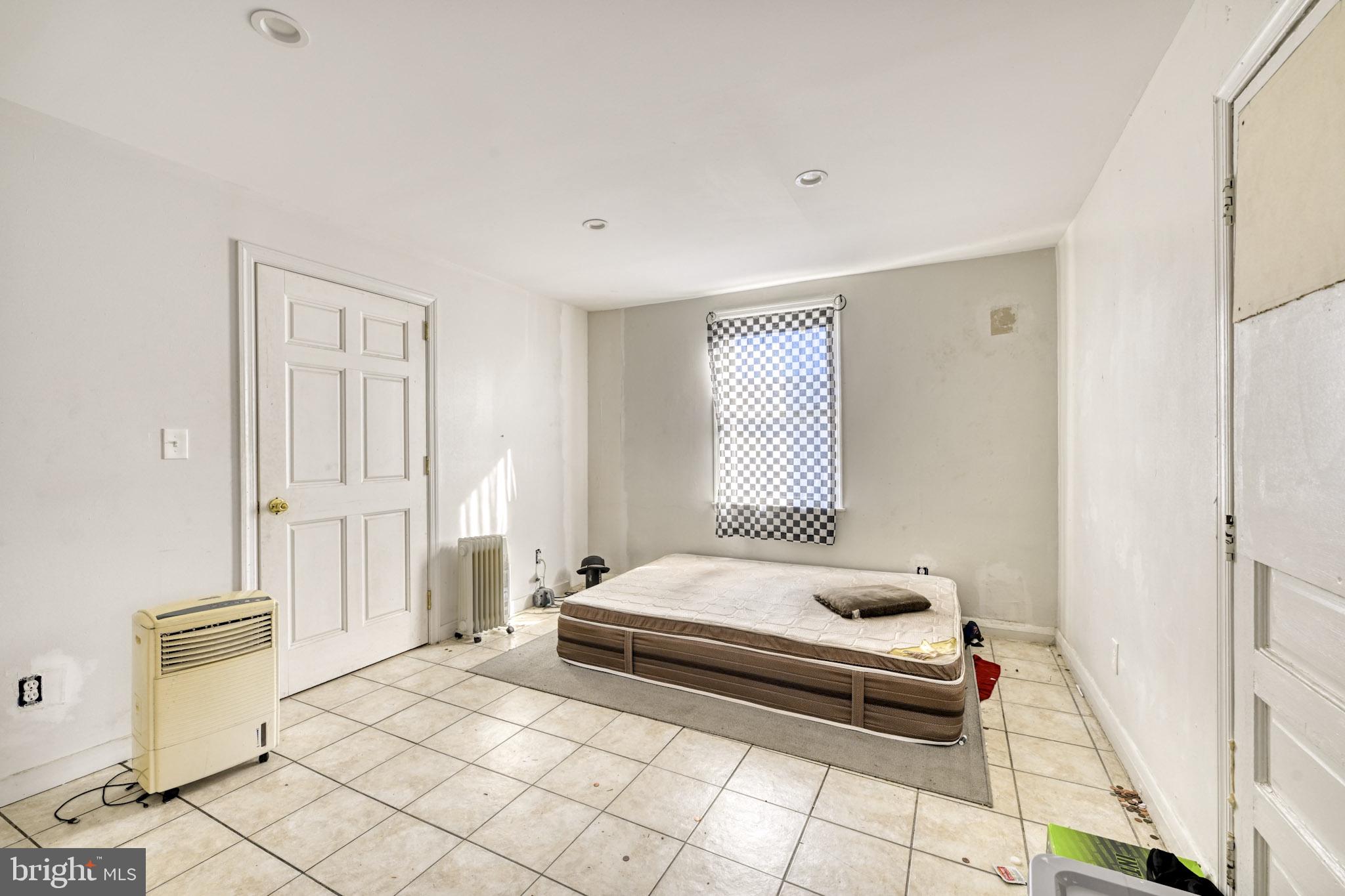 466 Hornel Street Baltimore, MD 21224 - Photo 6 of 19 a bedroom with a bed and a window