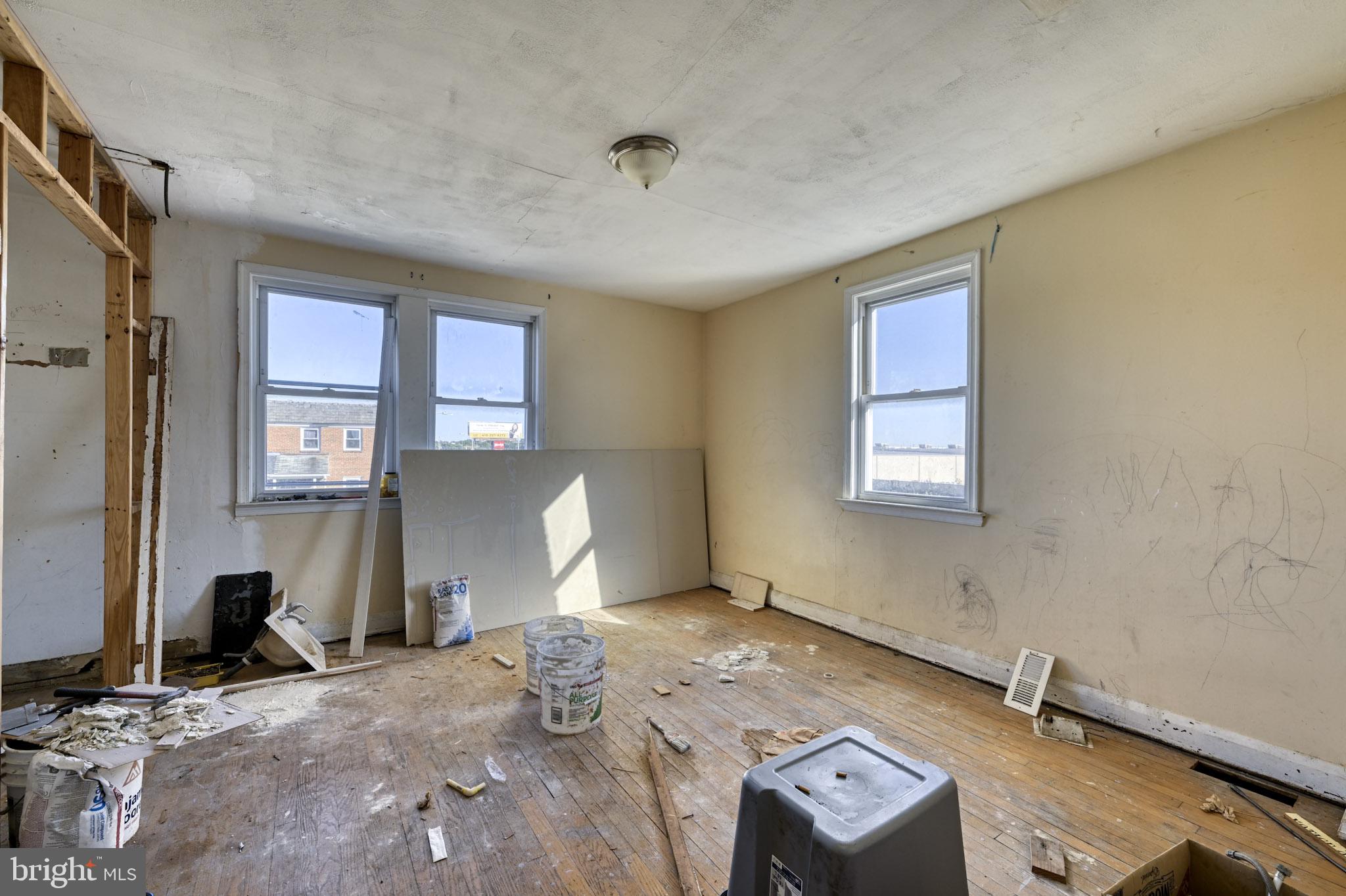 466 Hornel Street Baltimore, MD 21224 - Photo 7 of 19 a view of a livingroom with lounge chair and windows