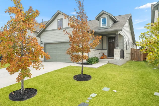 a front view of a house with garden