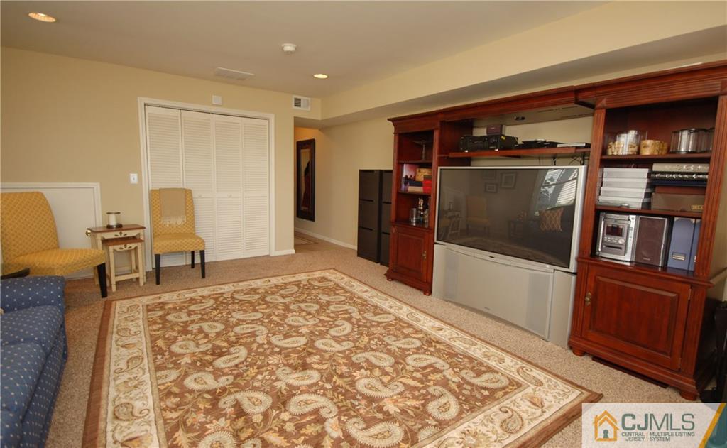 40 Raritan Reach Road, Unit 20 South Amboy, NJ 08879 - Photo 22 of 25 a living room with a couch and a dresser