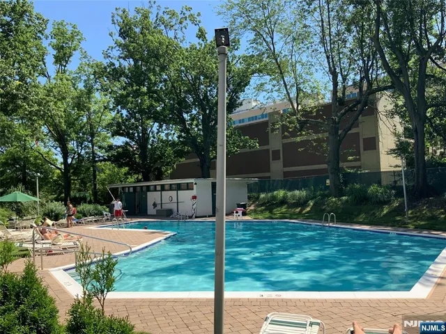 a view of a patio with a table and chairs and a small yard