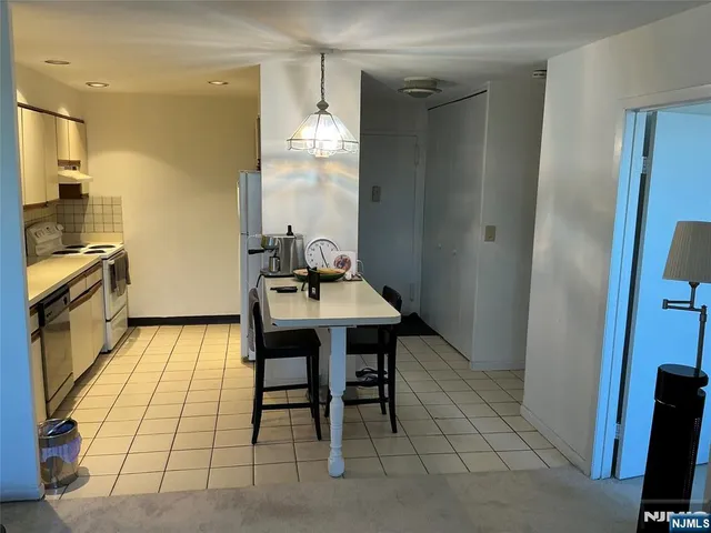a kitchen with a sink and breakfast area